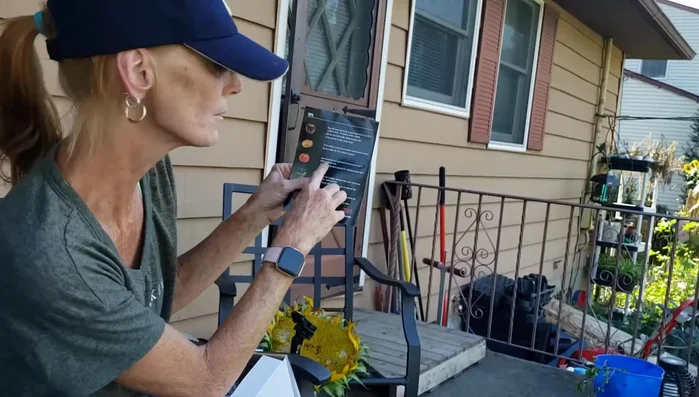 Woman reading food mill instructions