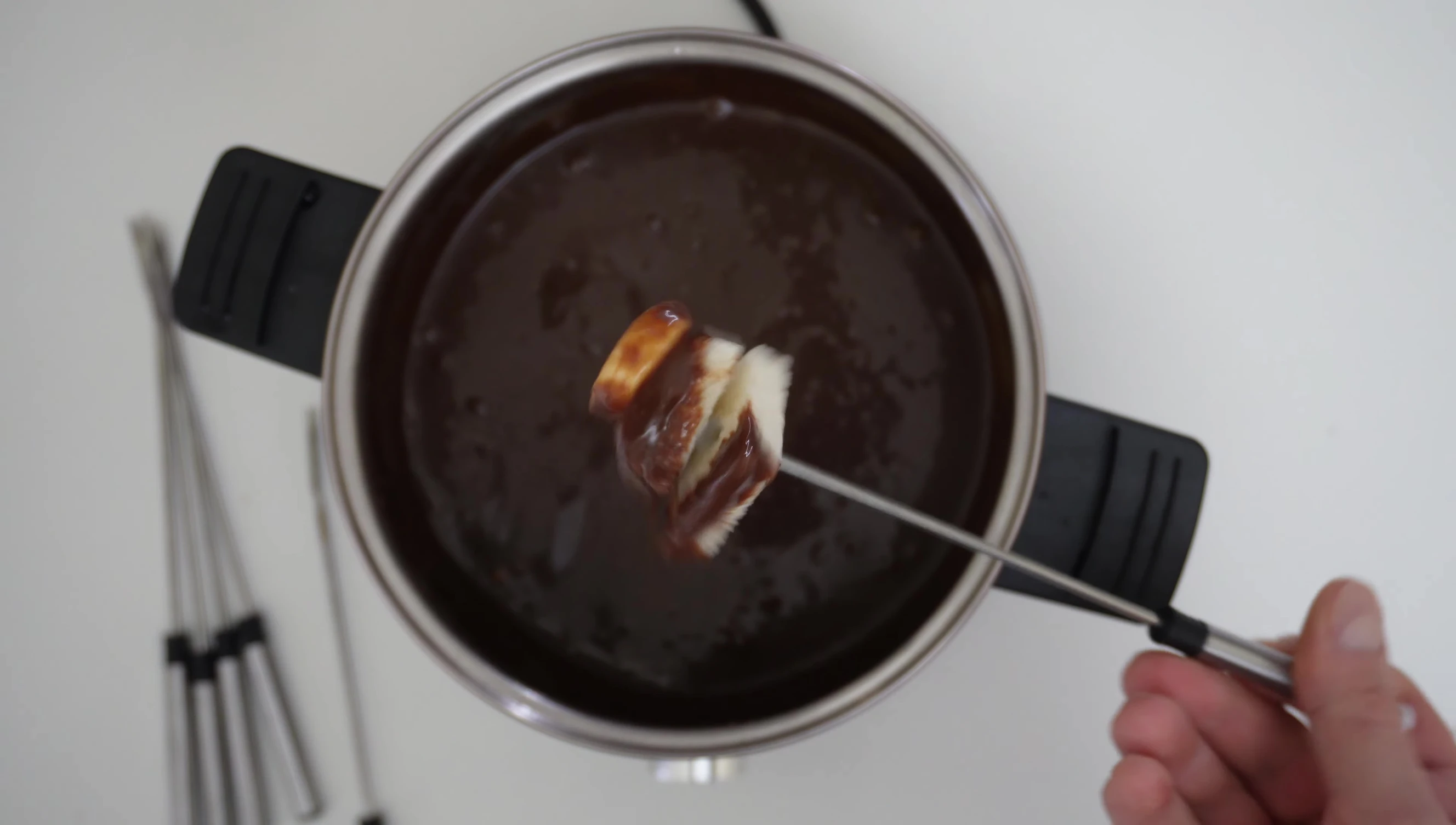 Cheese fondue being dipped with bread