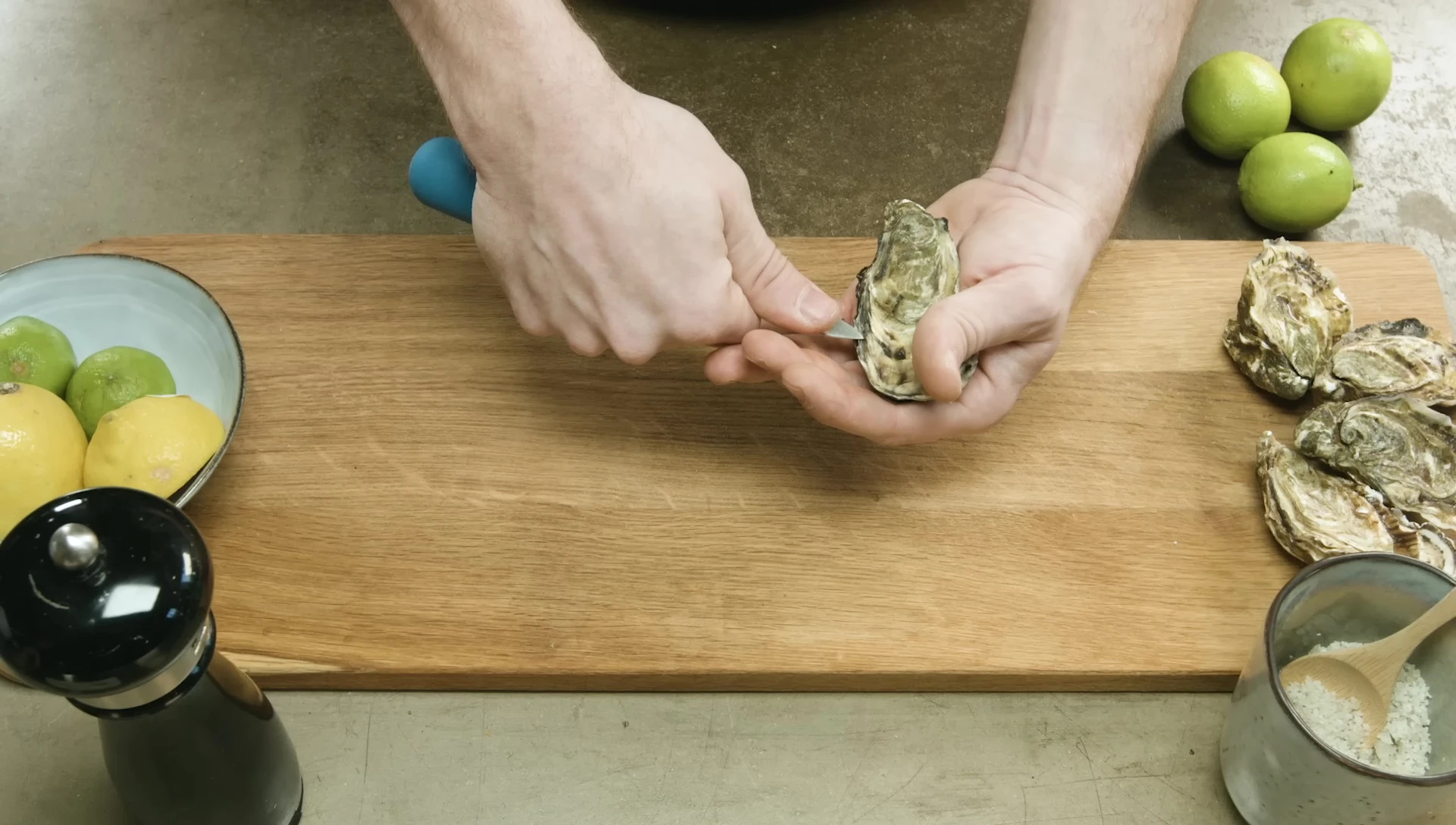 Shucking oysters with a small knife.