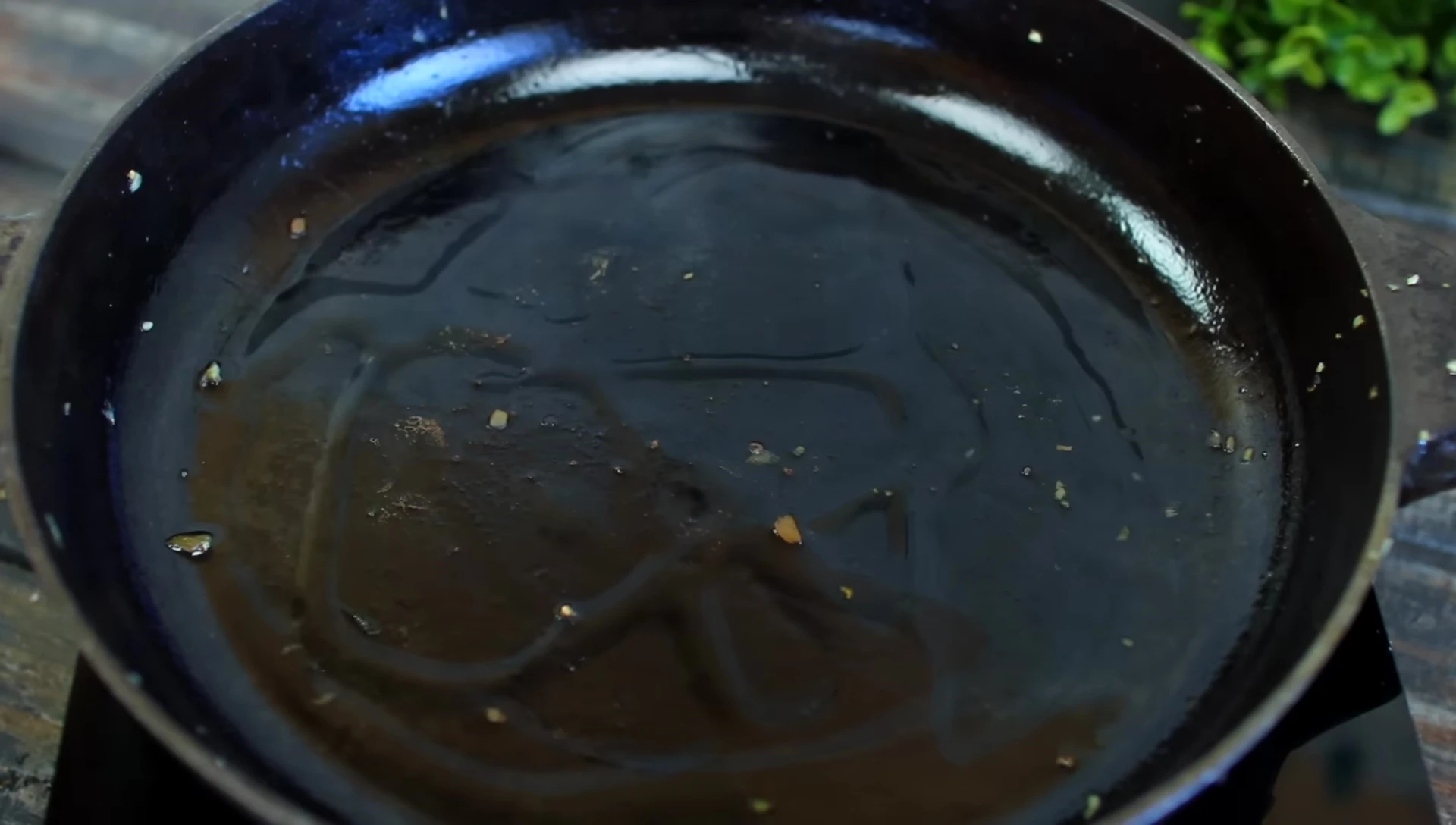 Oil in a hot skillet, ready for searing.